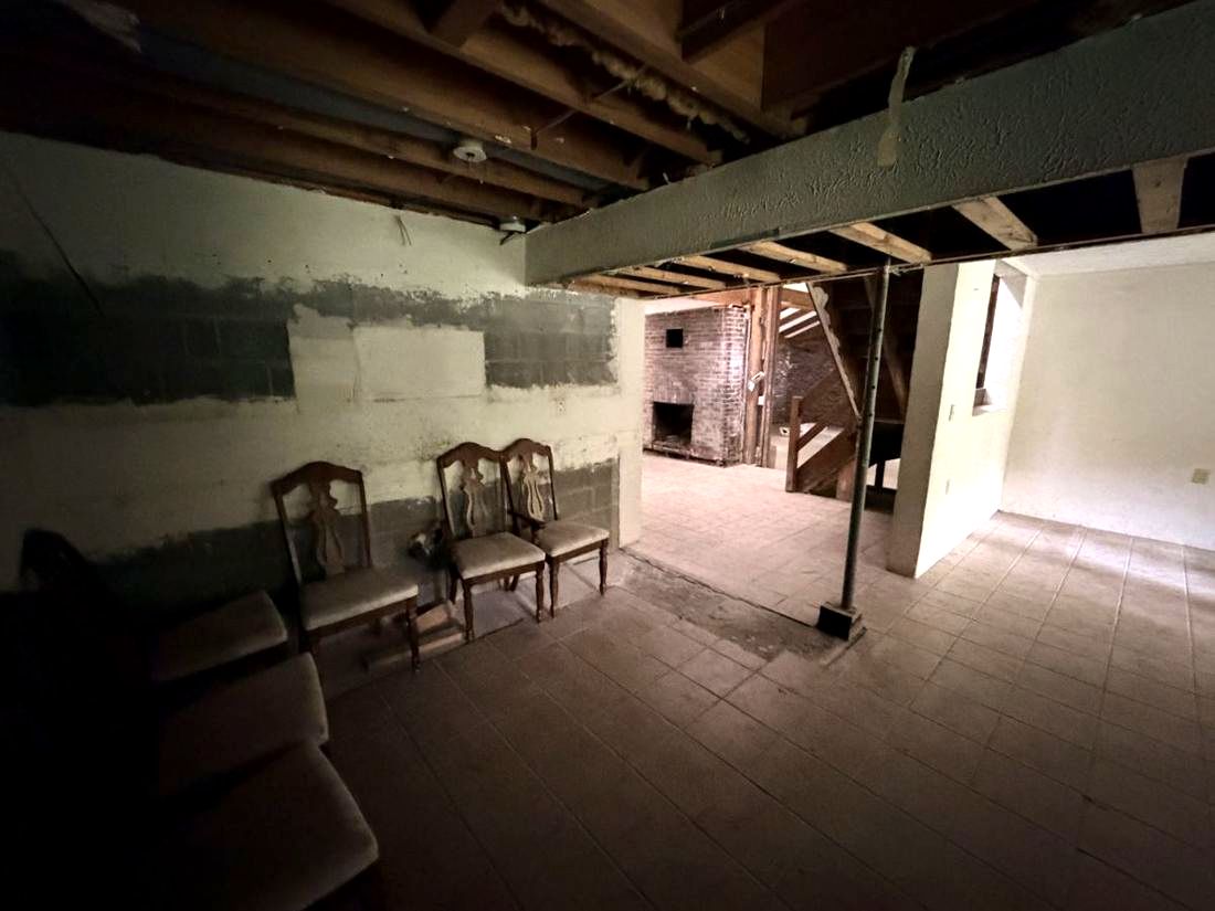 Lower level block walls with a visible waterline from previous flooding