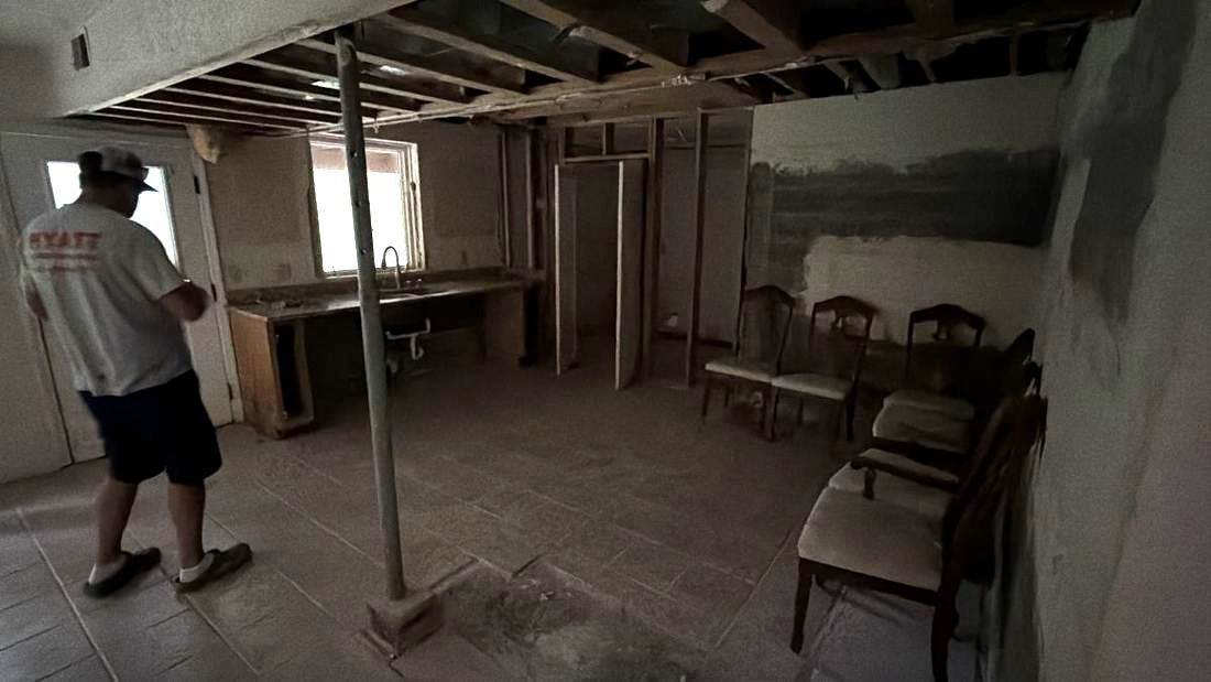 Lower level of a Kentucky renovation with the ceiling opened up, joists and mechanicals exposed