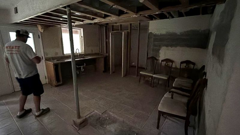 Lower level with the ceiling opened up, joists and mechanicals exposed