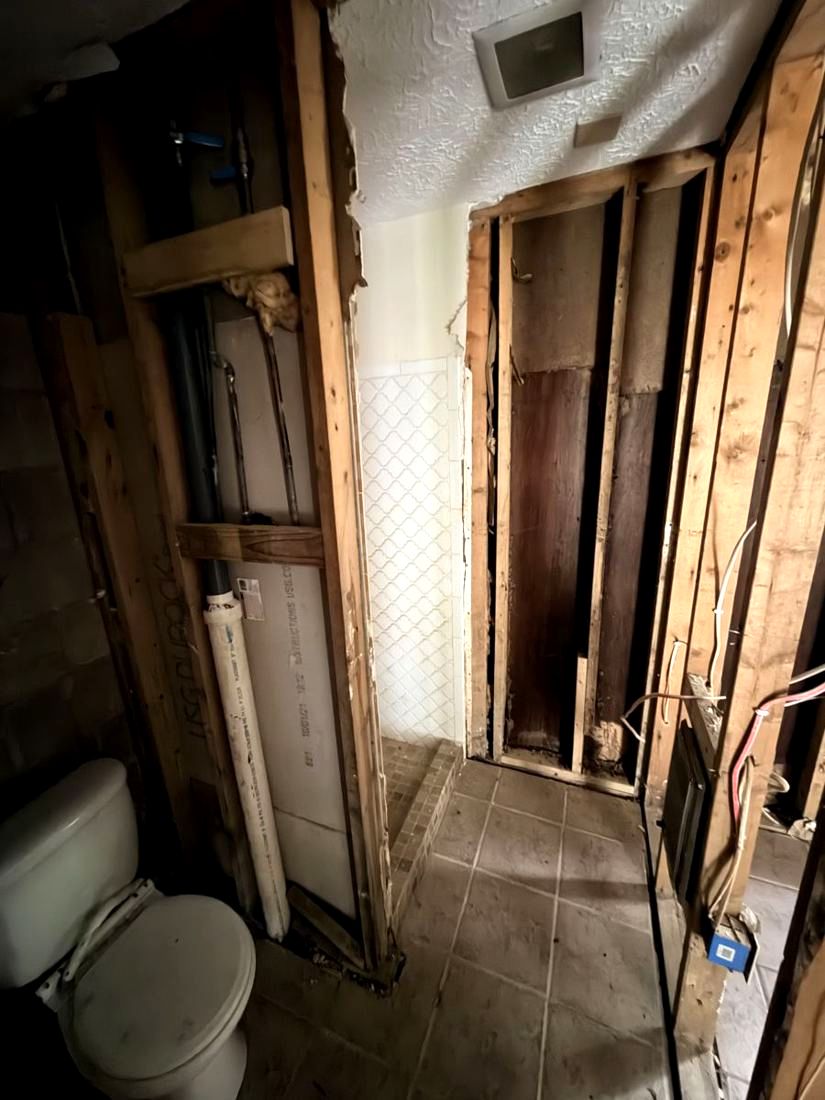 An upstairs bathroom opened to the studs during pre-construction assessment